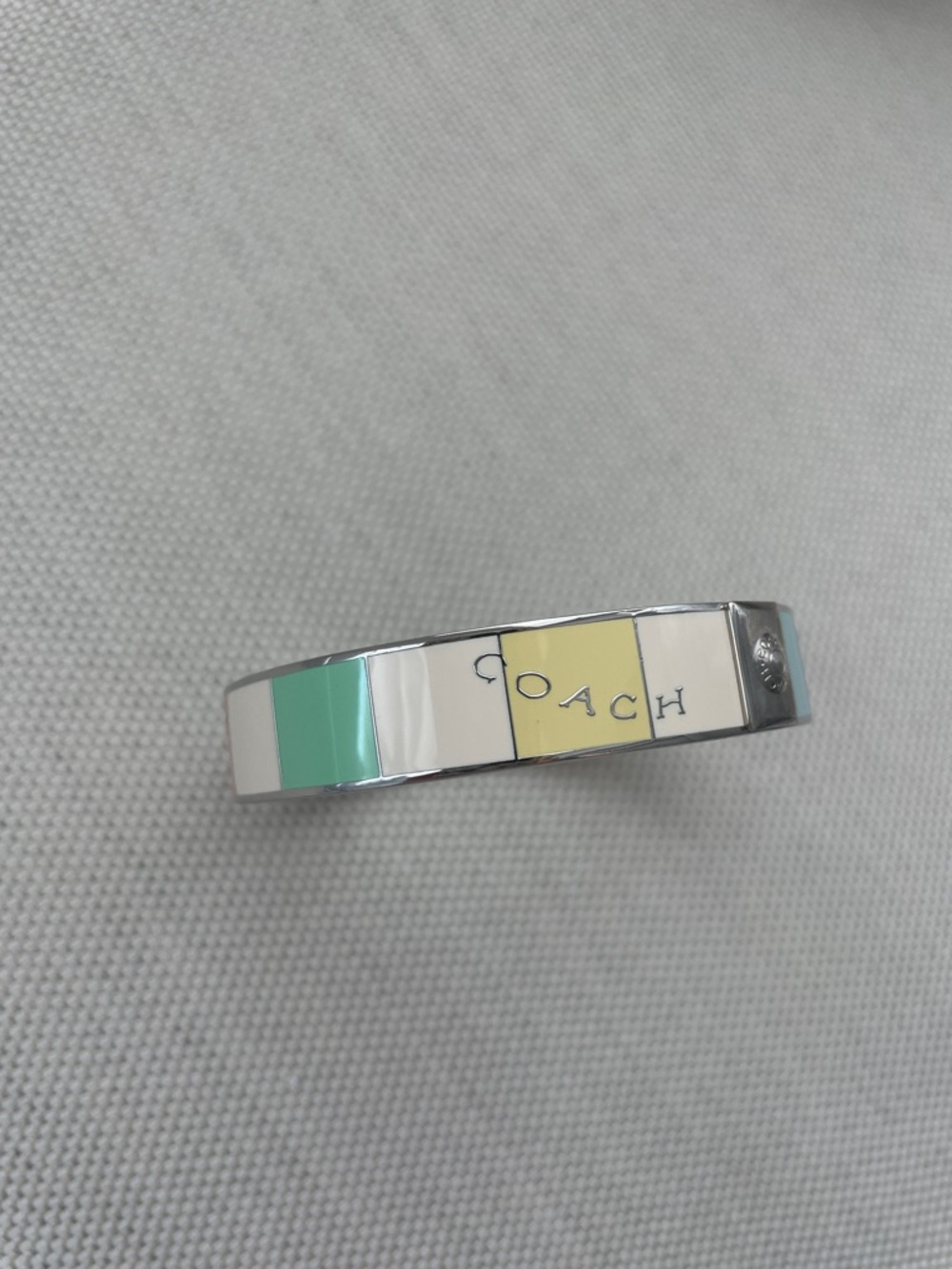 Coach Enamel Logo Bangle in Mint, White, Pale Yellow, Light Blue, and Coral
